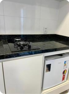a stove top oven sitting on top of a kitchen counter at Suíte completa com cozinha próximo ao mar in Torres +1 photo