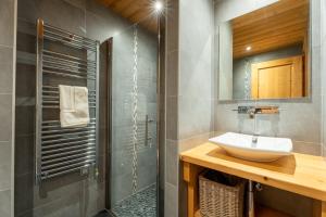 a bathroom with a sink and a shower at Chalet Virolet Jacuzzi Hammam Cheminée 15 pers - MultiPass in Les Gets +48 photos