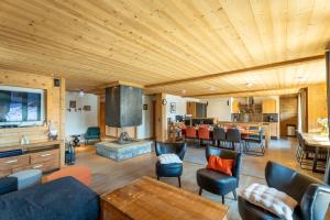 a large living room with a wooden ceiling at Chalet Virolet Jacuzzi Hammam Cheminée 15 pers - MultiPass in Les Gets