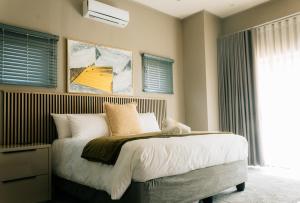 a bedroom with a bed with white sheets and pillows at Villa Limonero in Naboomspruit +25 photos
