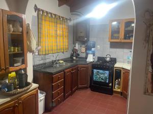 a kitchen with a sink and a stove top oven at Casa de Piedra in El Rodeo +7 photos