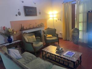 a living room with a couch and chairs and a table at Casa de Piedra in El Rodeo