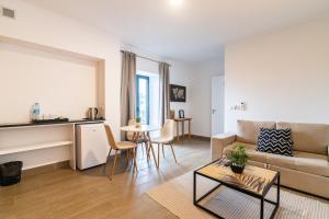 a living room with a couch and a table at Vila Rosario in Ponta Delgada