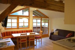 a living room with a table and a couch at Bio-Bauernhof Nichlgut in Eben im Pongau