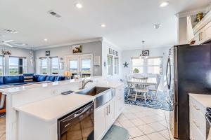 a kitchen with white countertops and a dining room at Gulf Breezes Unit A in Port Aransas