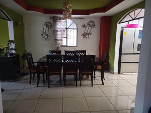 a dining room with a black table and chairs at Quinta Los Guacamayos in El Picacho