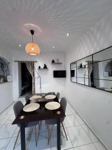 a dining room with a black table and chairs at Maria’ s apartment in Lavrio +17 photos