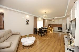 a living room with a couch and a table at Apartments Rivera in Dobrich