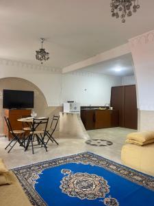 a living room with a table and a couch at Appartement Marrakech in Marrakesh