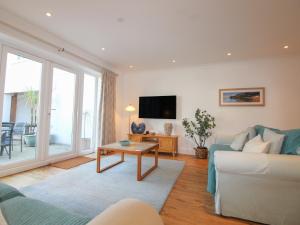 a living room with a couch and a table at 16 Bolt Head in Salcombe
