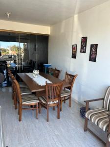 a dining room with a table and chairs at Pedra Branca Retreat in Garopaba