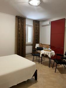 a hotel room with a bed and a table and chairs at B&B Azzurra in Pescara