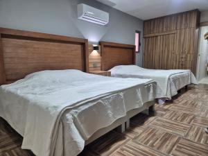 two beds in a hotel room with at Hermosa suite anakoba 3 in La Concha