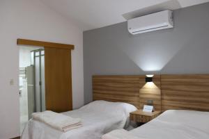 a bedroom with two beds and a air conditioner on the wall at Hermosa suite anakoba 3 in La Concha