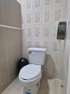 a bathroom with a toilet and a wall at Hermosa suite anakoba 3 in La Concha +9 photos