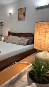a bedroom with a bed and a table with a lamp at Apartman Stone Garden in Mostar