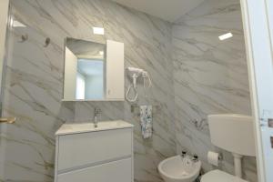 a bathroom with a sink and a toilet and a mirror at Casa Estação Douro Vista in Vila Marim