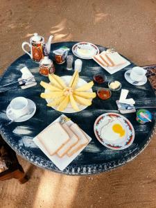 a blue table with a plate of food on it at Jasmin Garden in Kalutara +14 photos