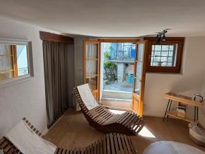 a living room with two chairs and a window at Casa Mille Sassi in Lionza