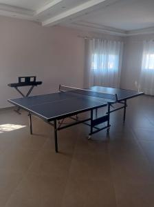 a ping pong table in the middle of a room at Résidence Mialy in Manankasina