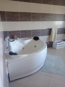 a white bath tub sitting in a bathroom at Résidence Mialy in Manankasina +16 photos