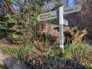 a street sign for the intersection of wilsontotide revisionarity fifty at Royal Oak Rooms in Exeter