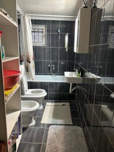 a bathroom with two toilets and a shower at Apartman Stone Garden 2 in Mostar +31 photos