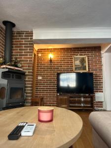 a living room with a coffee table and a tv at Apartman Stone Garden 2 in Mostar