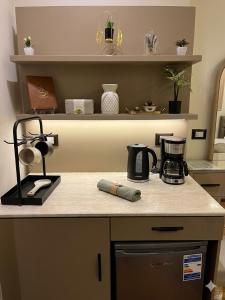 a kitchen counter with a coffee maker on it at New LH Cairo Hotel in Cairo