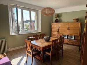 a dining room with a wooden table and chairs at TOUCY Vintage in Toucy