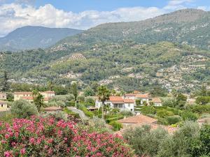 a view of a town with mountains and flowers at Gite Mireille in Carros
