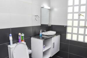 a bathroom with a toilet and a sink and a mirror at Pacificas place in Eldoret +19 photos