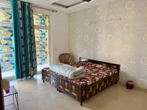 a bedroom with a bed in the corner of a room at Pradise in Mohali