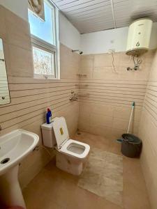 a bathroom with a white toilet and a sink at Pradise in Mohali +16 photos