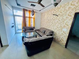 a living room with two couches and a glass table at Pradise in Mohali