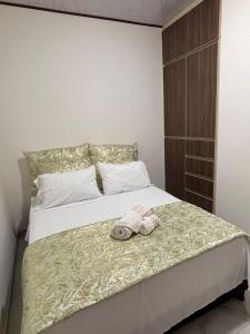 a bedroom with a bed with a stuffed animal on it at Aparta Hotel La Osadía in Acacías