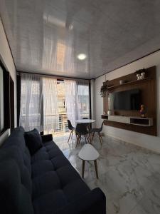 a living room with a couch and a table at Aparta Hotel La Osadía in Acacías