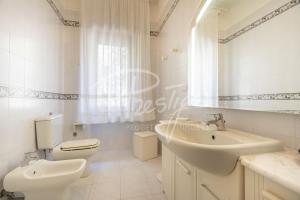 a white bathroom with a toilet and a sink at Villa Elena in Portovenere +8 photos