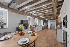 a kitchen and dining room with a wooden table at 9 Bed in Alkham oc-m34784 in Swingfield