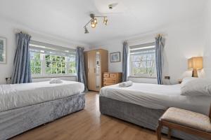 a bedroom with two beds and two windows at 9 Bed in Alkham oc-m34784 in Swingfield +61 photos