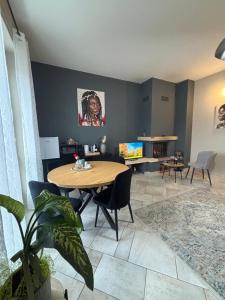 a living room with a wooden table and chairs at Suite Altura in Cuneo +13 photos