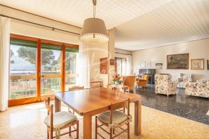 a dining room with a table and chairs at Villa Elena in Portovenere