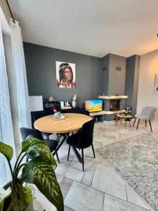 a living room with a wooden table and chairs at Suite Altura in Cuneo