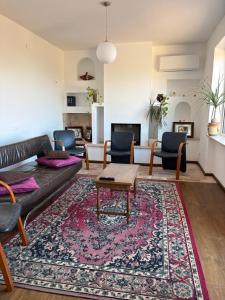 a living room with a couch and a rug at B&B Azzurra in Pescara