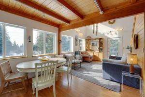 a dining room and living room with a table and chairs at Bring Your Pets! Secluded Homer Escape w/ Deck in Homer