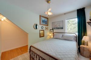 a bedroom with a bed and a stair case at Bring Your Pets! Secluded Homer Escape w/ Deck in Homer