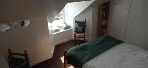 a small bedroom with a bed and a window at ABC Bladnoch in Newton Stewart