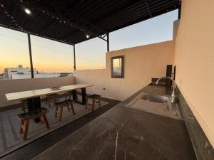 a kitchen with a table and chairs on a roof at Casa Conchalito in La Paz