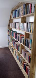 a row of book shelves filled with books at ABC Bladnoch in Newton Stewart