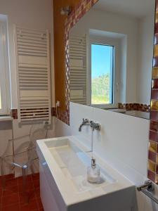 a bathroom with a sink and a mirror at B&B Azzurra in Pescara +57 photos